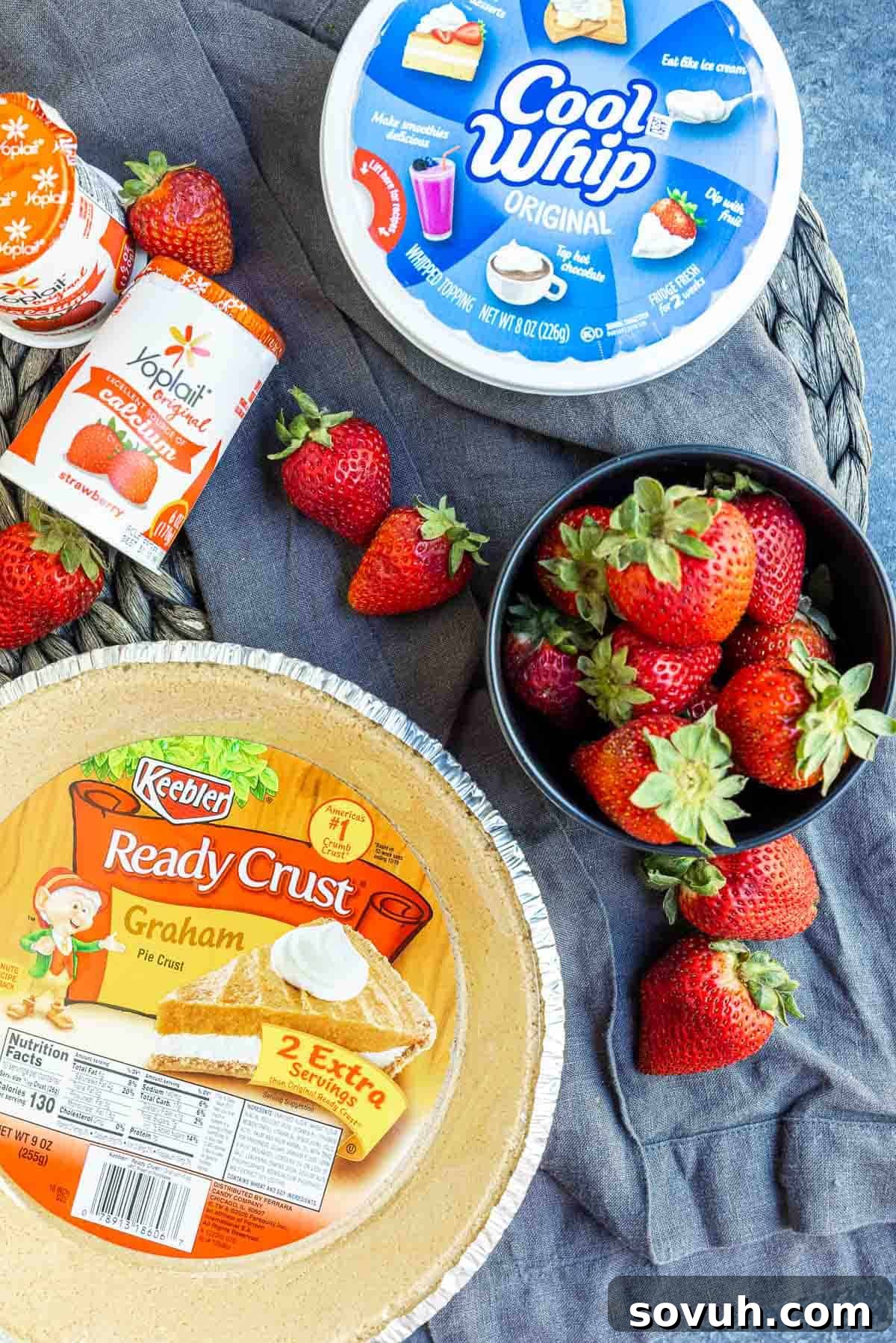 Ingredients for Frozen Strawberry Pie laid out on a surface