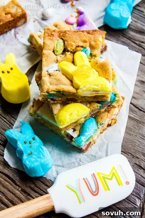 Colorful Easter Blondies 4 Vertical shot of Easter Candy Blondies, showcasing a thick, chewy bar topped with colorful Easter candy and marshmallow Peeps. Perfect for sharing at Easter gatherings.