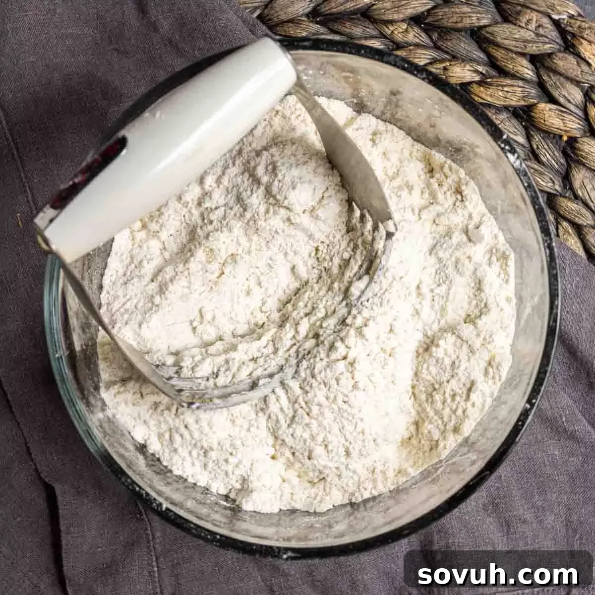 adding butter to dough for easy blackberry cobbler