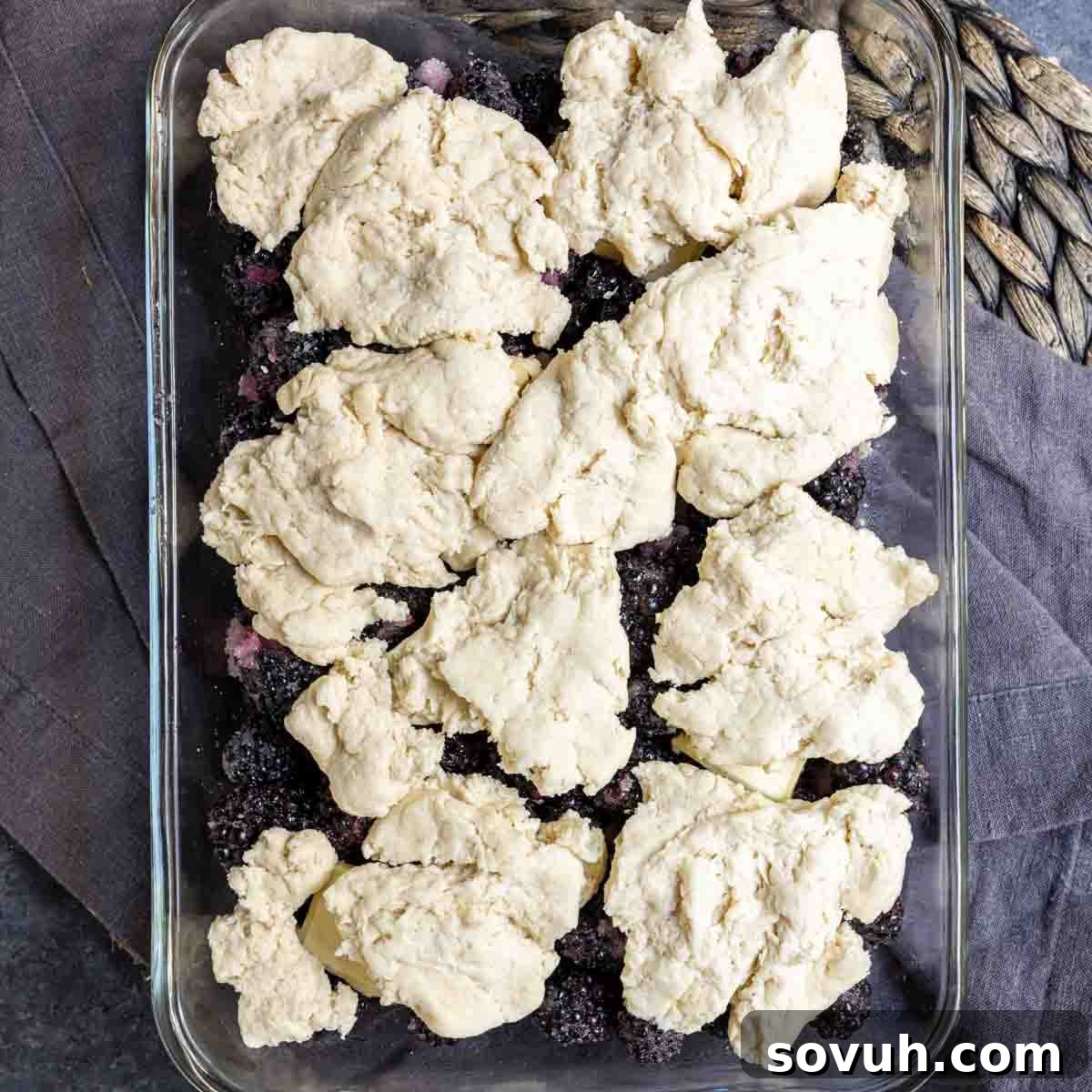 raw dough on top of easy blackberry cobbler in dish