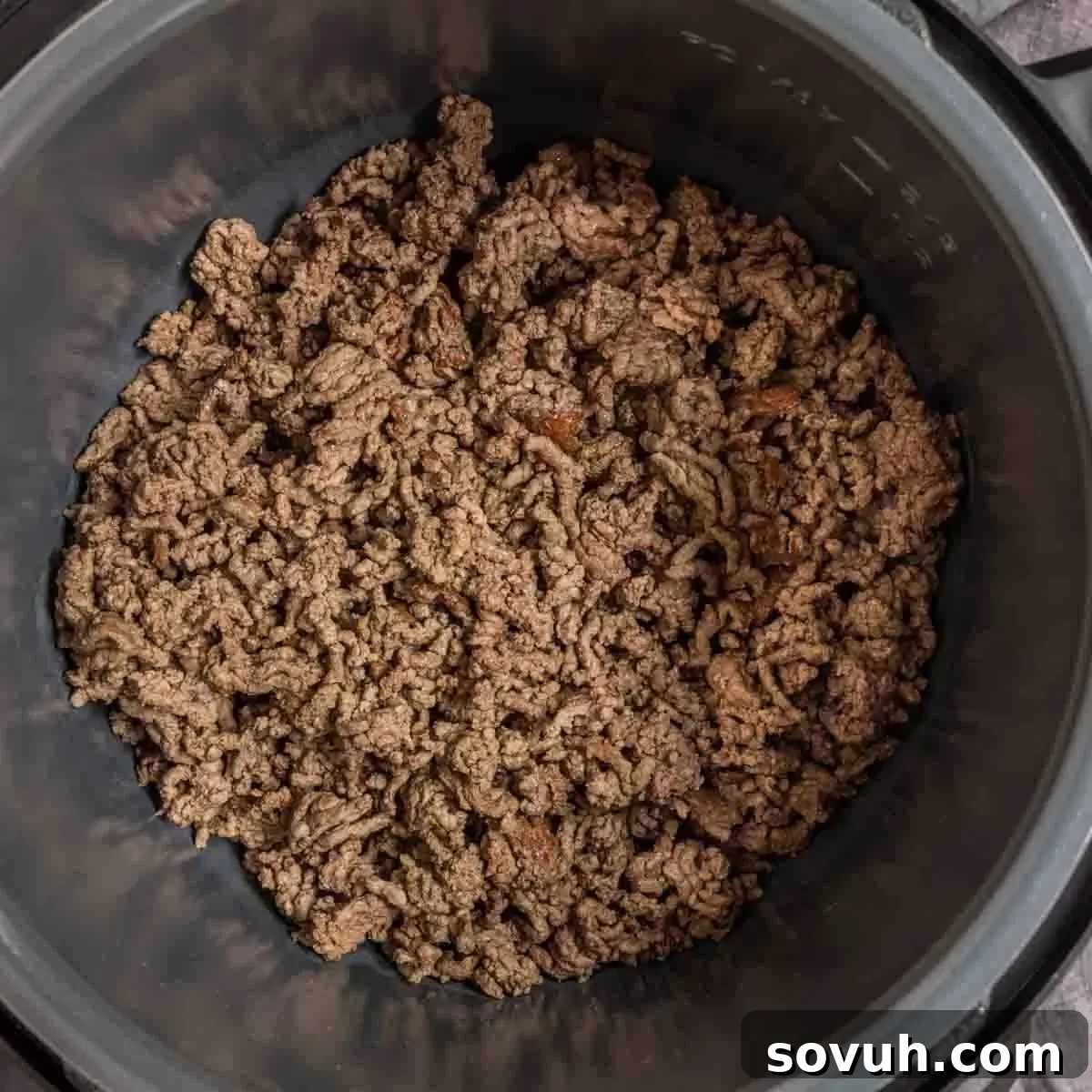 Ground beef browning inside an Instant Pot, a key first step for a flavorful Instant Pot Taco Soup, ensuring a rich base.