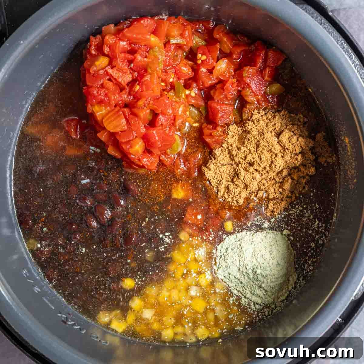 All the vibrant ingredients for Instant Pot Taco Soup, including spices, broth, beans, and corn, perfectly combined and ready to be pressure cooked to perfection.