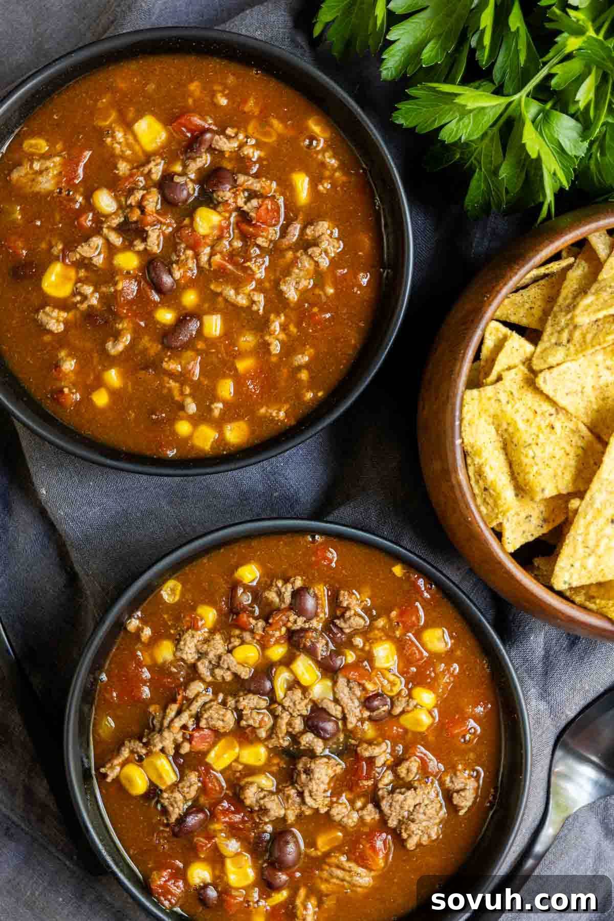 Another enticing view of a bowl of Instant Pot Taco Soup, richly garnished and ready to be enjoyed with a side of crunchy tortilla chips.