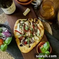 Balsamic Glazed Chicken Naan Pizza with fresh basil and balsamic drizzle, ready to eat