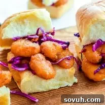 Bang Bang Shrimp Sliders | These easy Bang Bang Shrimp Sliders are sweet and spicy and full of flavor. They take a delicious copycat Bang Bang Shrimp recipe and put it on a slider bun with a cool and crisp red cabbage slaw. This is an amazing appetizer recipe that is an easy party appetizer or a quick and easy weeknight dinner idea.