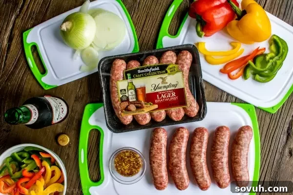 Ingredients for Beer Brat Sliders, including Smithfield Yuengling Brats, pretzel buns, cheese, onions, bell peppers, Yuengling Lager, butter, and whole grain mustard.