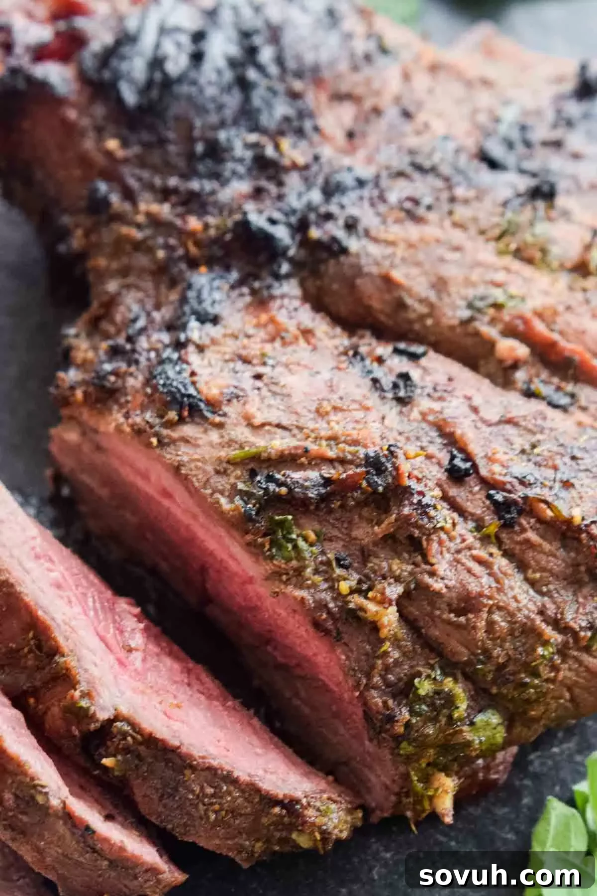 close up of sliced leg of lamb showing pink center