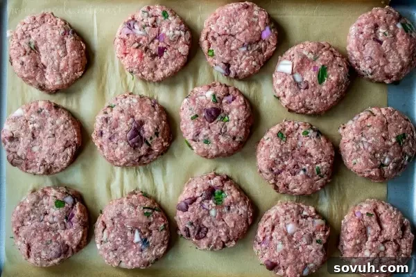 Greek Sliders | These easy Greek Sliders make an awesome appetizer recipe for parties. Make this football party food when you watch the game or serve them as an easy appetizer recipe at a cookout. These grilled Greek sliders are grilled burgers topped with homemade tzatziki to make a delicious slider!