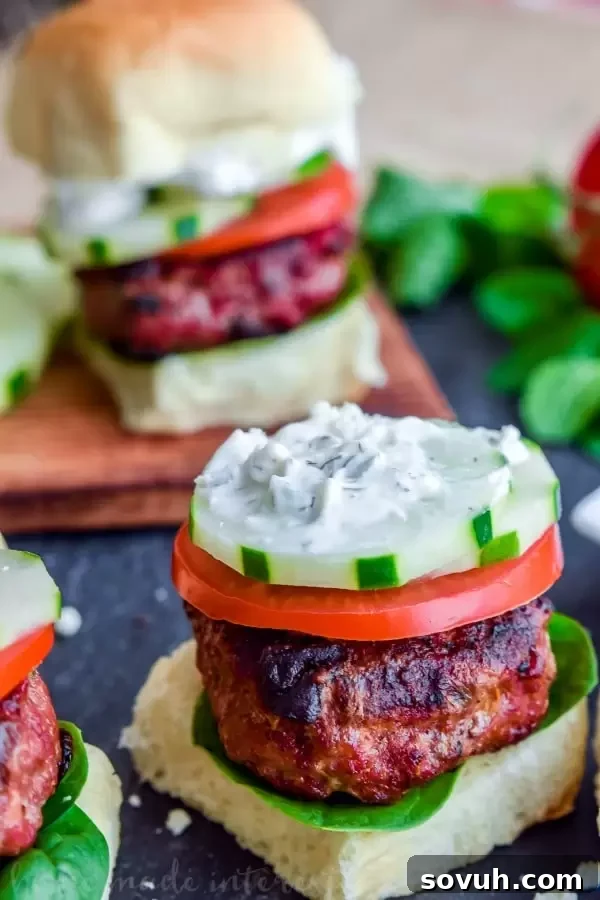 Greek Sliders | These easy Greek Sliders make an awesome appetizer recipe for parties. Make this football party food when you watch the game or serve them as an easy appetizer recipe at a cookout. These grilled Greek sliders are grilled burgers topped with homemade tzatziki to make a delicious slider!