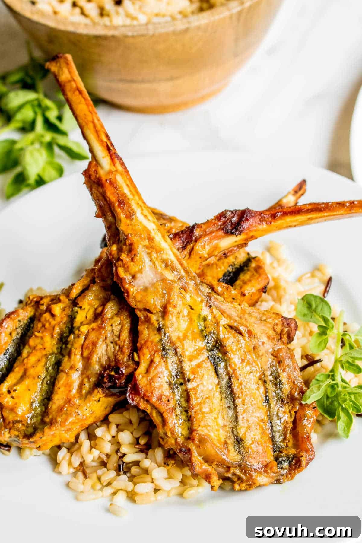 Freshly grilled Tandoori Lamb Chops served on brown rice, perfectly cooked and ready to enjoy.