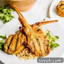 Two Grilled Lamb Chops in a Curry Marinade on top of brown rice