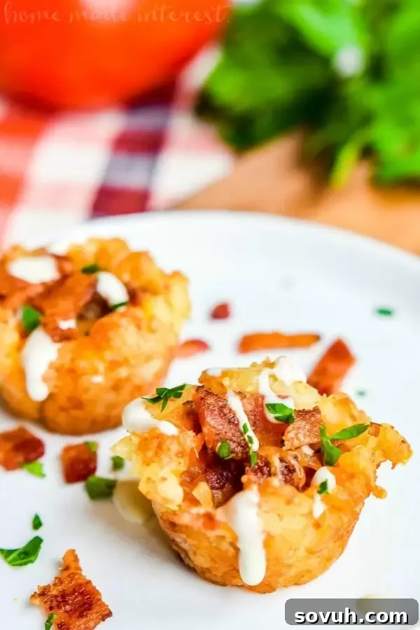 Vertical shot of Loaded Tater Tot Bites: Awesome game day appetizer filled with bacon, cheese, sour cream. Best potato appetizer for parties.