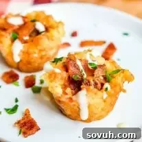 Loaded Tater Tot Bites: Crispy tater tot cups filled with bacon, cheese, and sour cream. Perfect easy game day appetizer or football party food.
