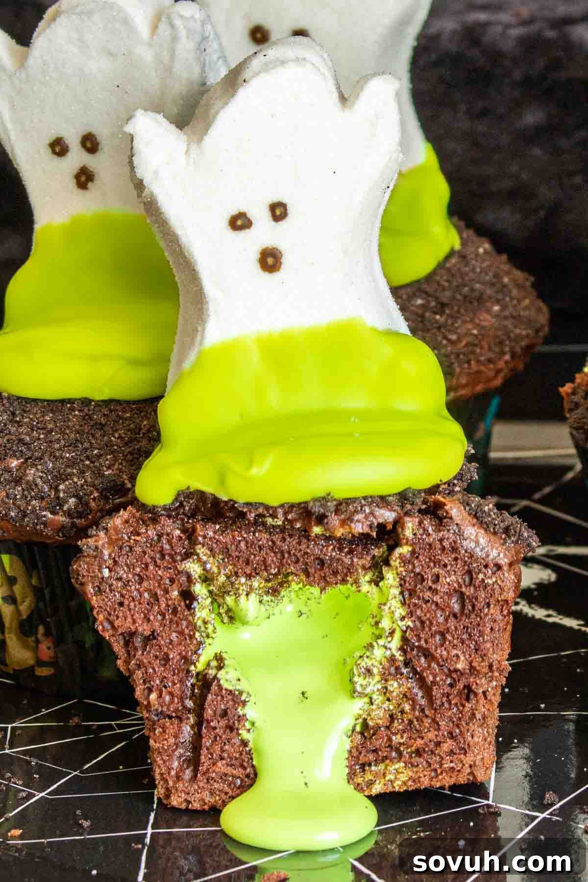 Pinterest image for Ghost Goo Halloween Cupcakes with title text, showing an oozing cupcake