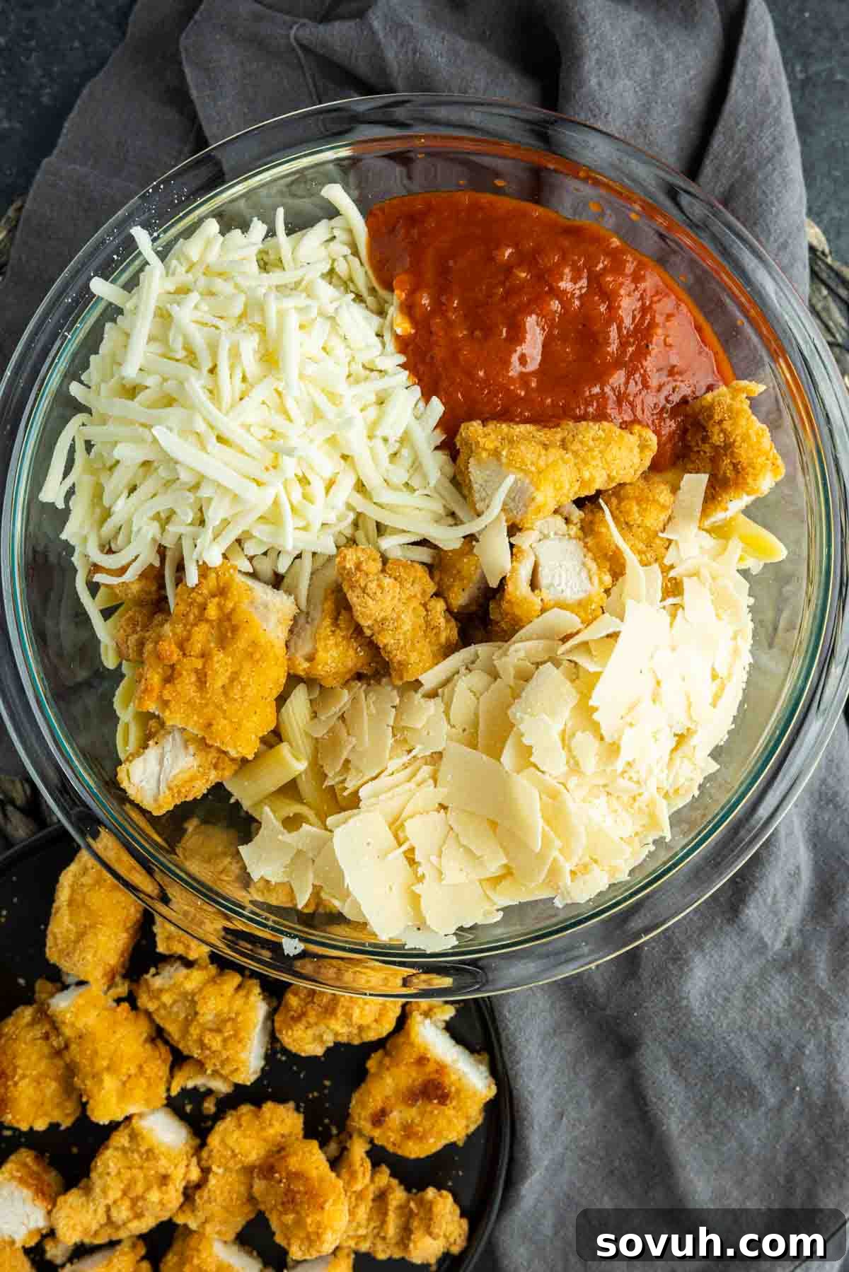 Cheesy Chicken Parm Bake 4 Step-by-step image showing how to combine ingredients for Chicken Parmesan Casserole in a large bowl.