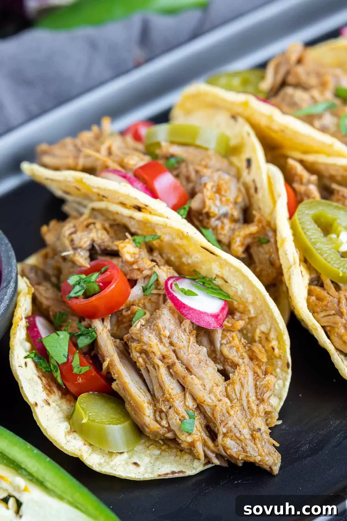 Platter of Pulled Pork Tacos served on corn tortillas, ready for a delicious meal