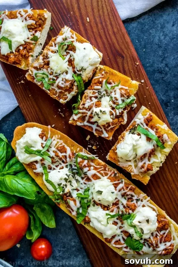 Lasagna French Bread Melts 4 whole lasagna french bread pizza with slices next to it on a wooden board