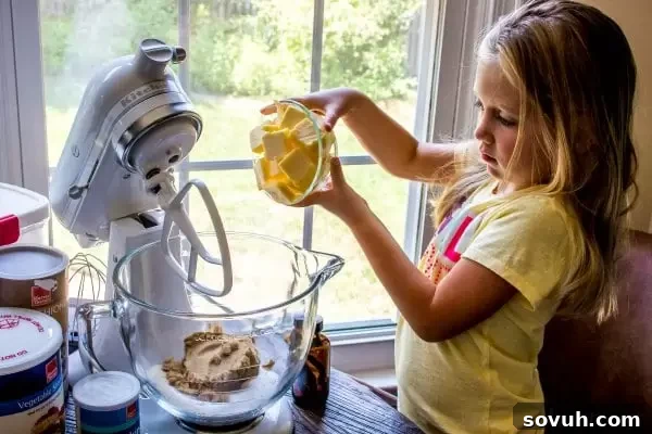 adding butter to peanut butter trail mix cookie mix