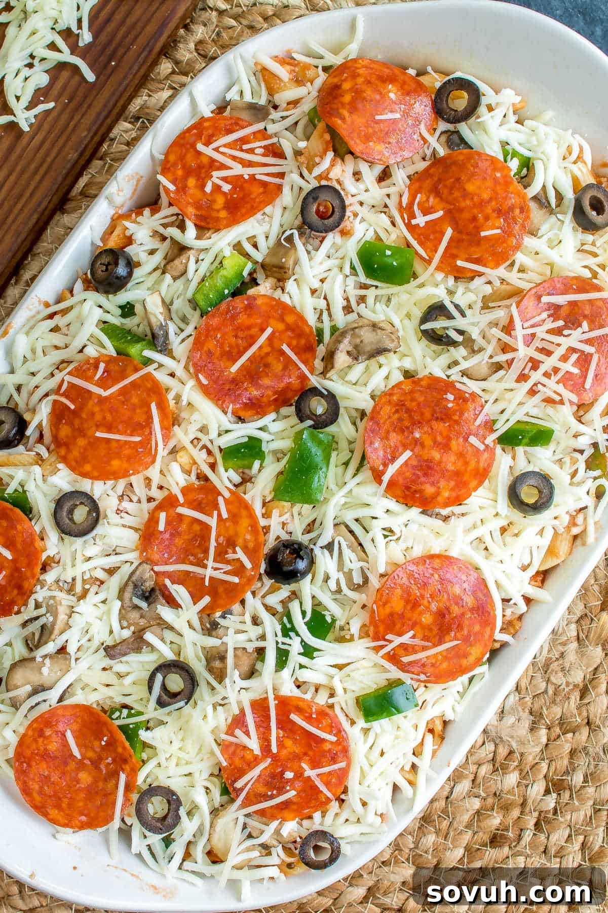 unbaked pizza casserole in white casserole dish
