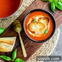 Roasted Red Pepper Soup in a pot and bowl, garnished