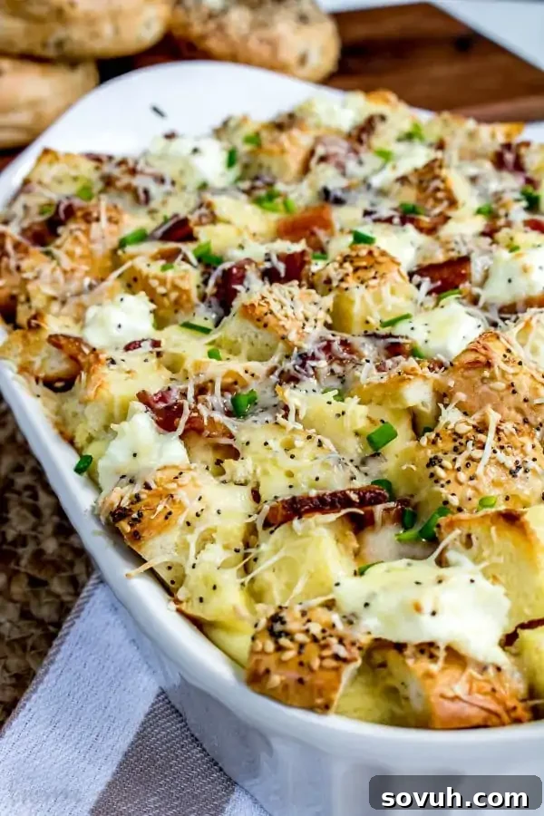 Vertical shot of Everything Bagel and Bacon Breakfast Casserole, freshly baked and garnished with chives.
