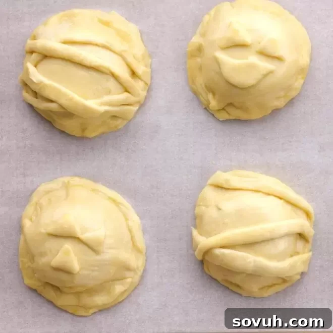 A Mini Babybel cheese and pepperoni slice placed on a puff pastry round, ready to be covered.