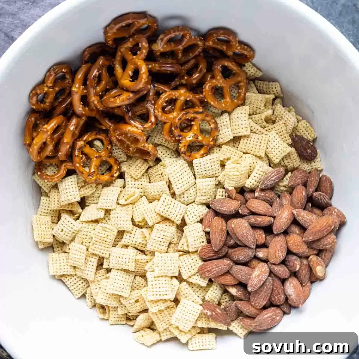 Mixing dry ingredients (Chex cereal, almonds, pretzels) for Bunny Bait