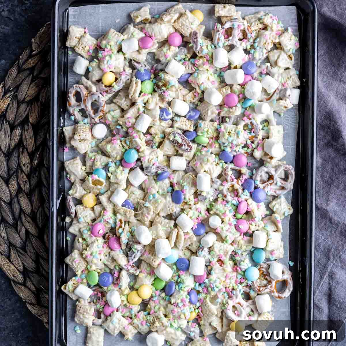 Bunny Bait cooling on a parchment paper-lined sheet pan with M&M's and marshmallows