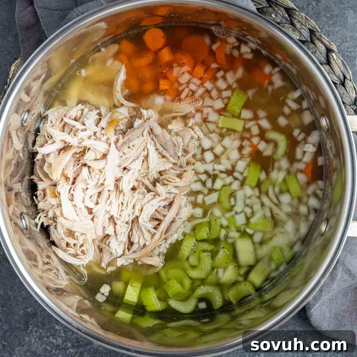 Ingredients for Rotisserie Chicken Soup with Tortellini simmering in a stock pot