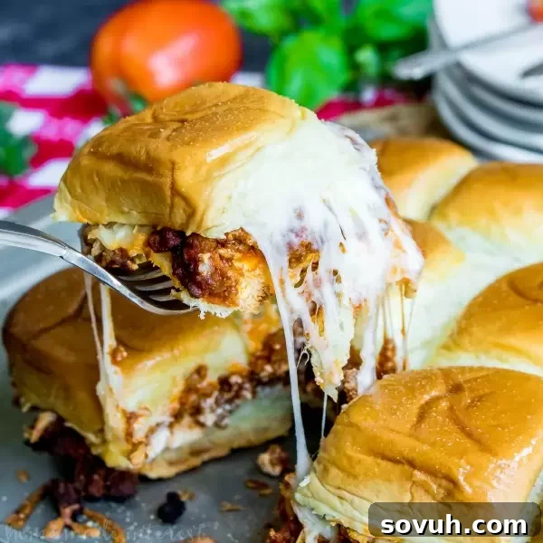 A delicious Lasagna Slider with melted cheese stretching out as it's pulled apart.