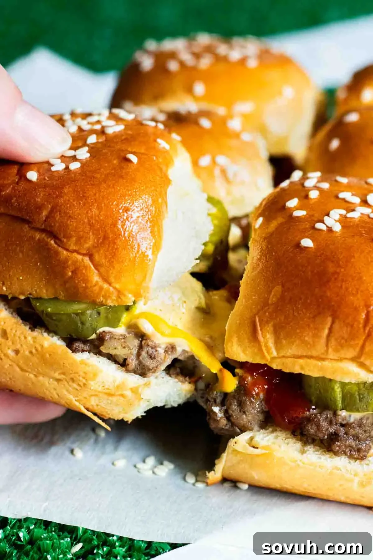 Homemade Big Mac Minis 3 A person is holding a Copycat Big Mac Slider with a bite taken out of it.