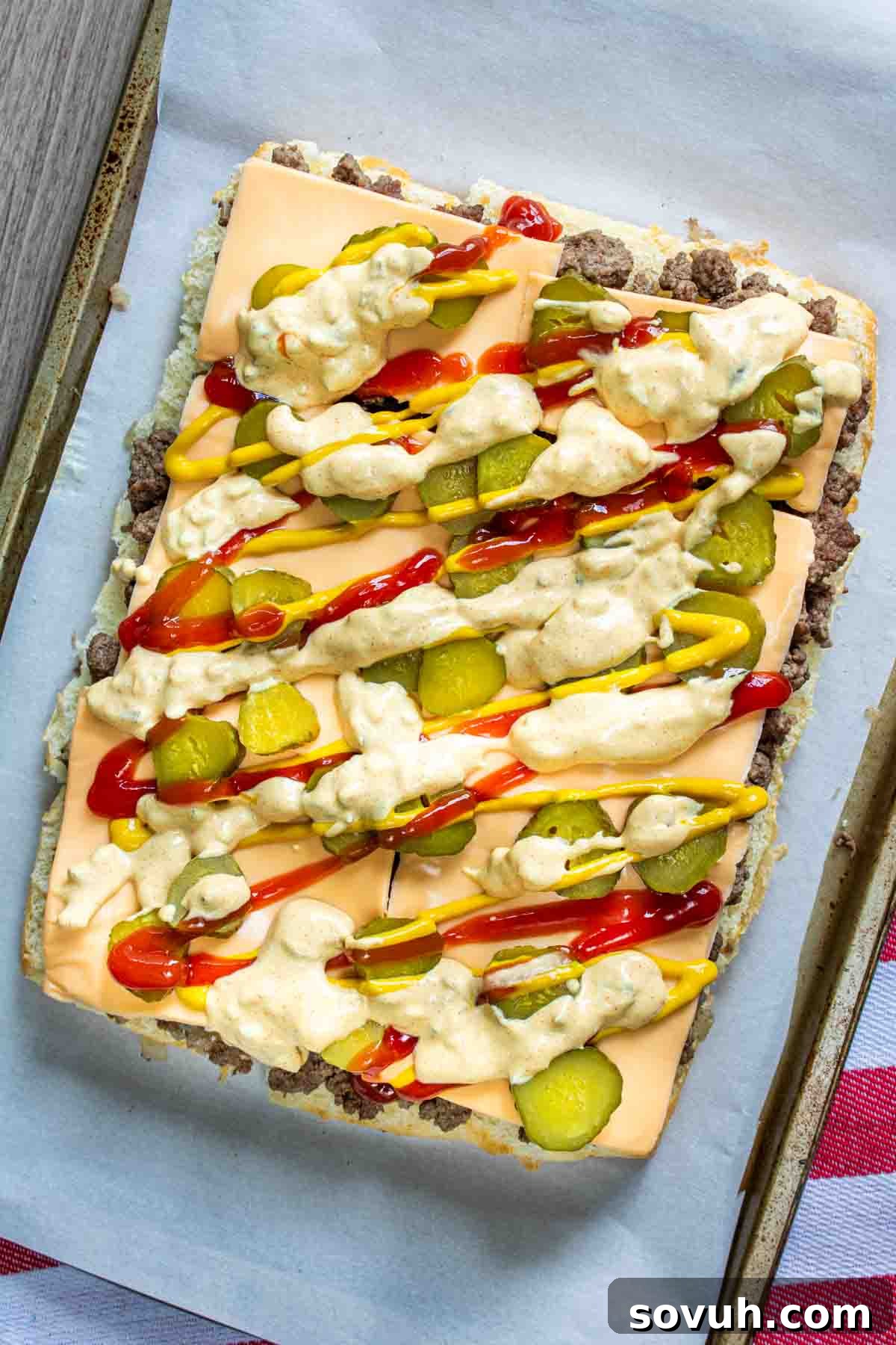 Homemade Big Mac Minis 5 Copycat Big Mac Sliders with a layer of ketchup and pickles before adding the top bun.