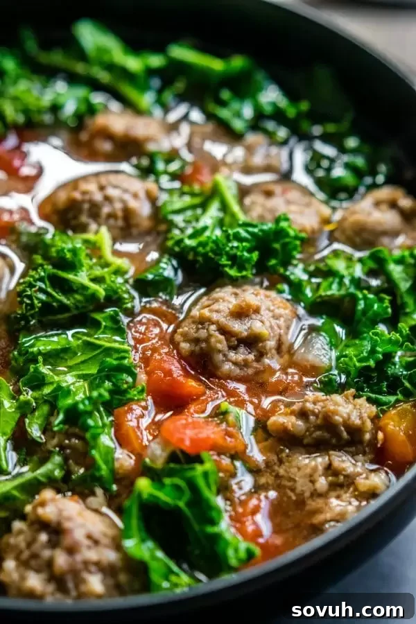 Close-up of low carb Instant Pot sausage and kale soup with vibrant tomatoes