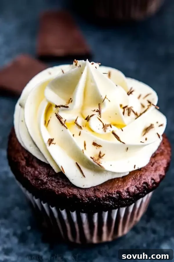 White chocolate frosting swirled on top of a dark chocolate cupcake.