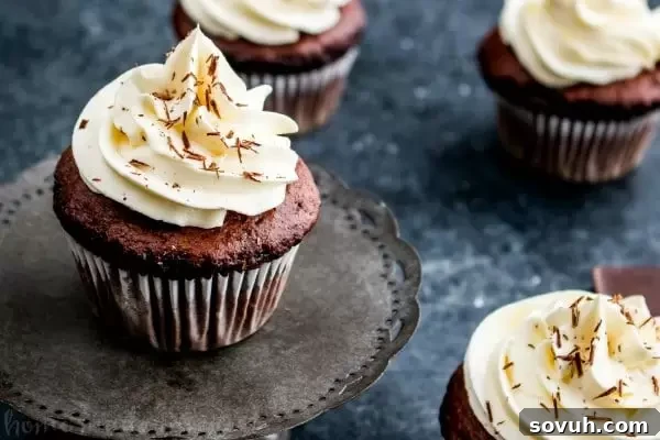 A trio of cupcakes showcasing the three chocolates: white, milk, and dark.