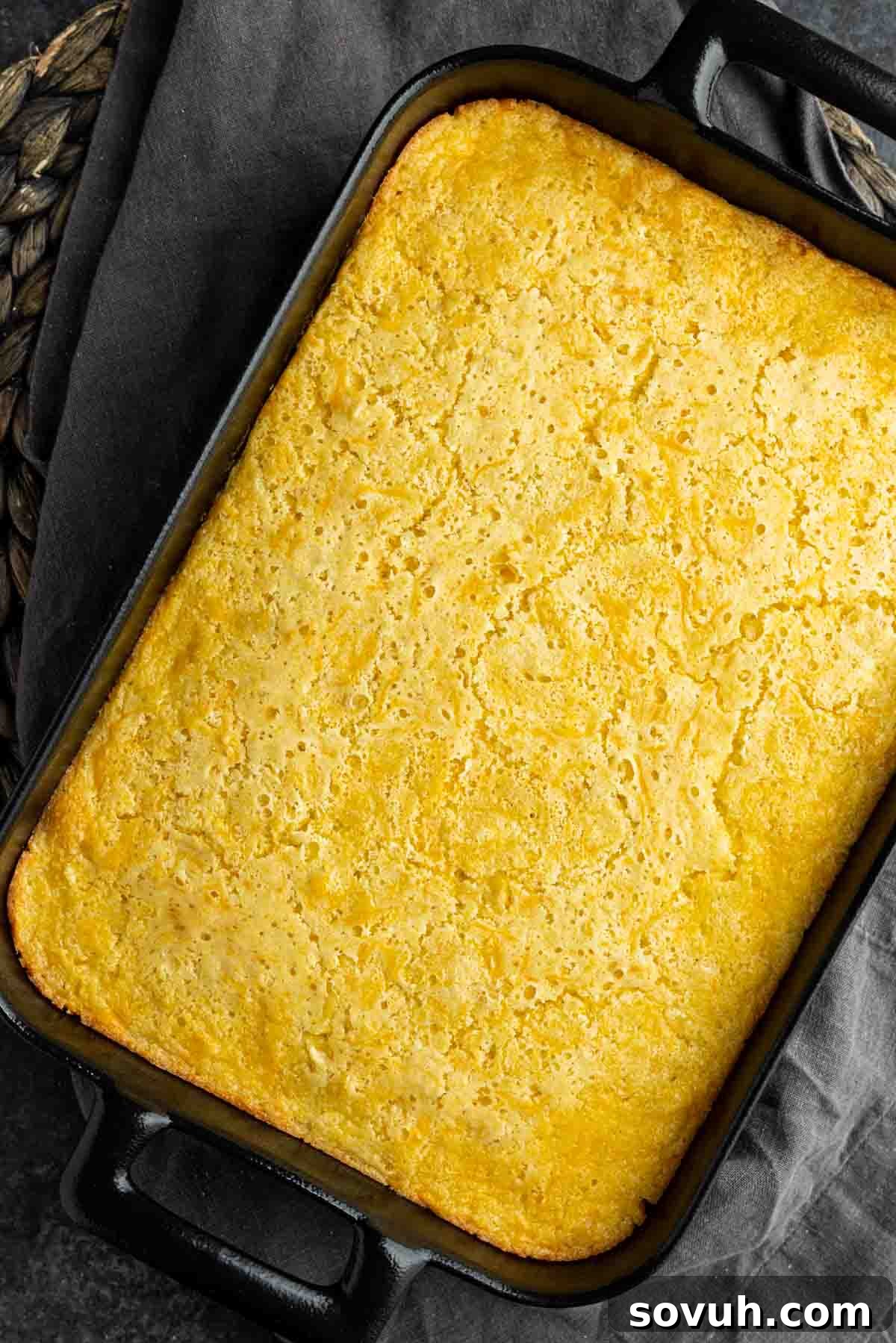 baked Creamed Corn Casserole on black casserole dish