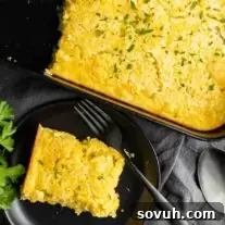 Creamed Corn Casserole on a black plate and fork