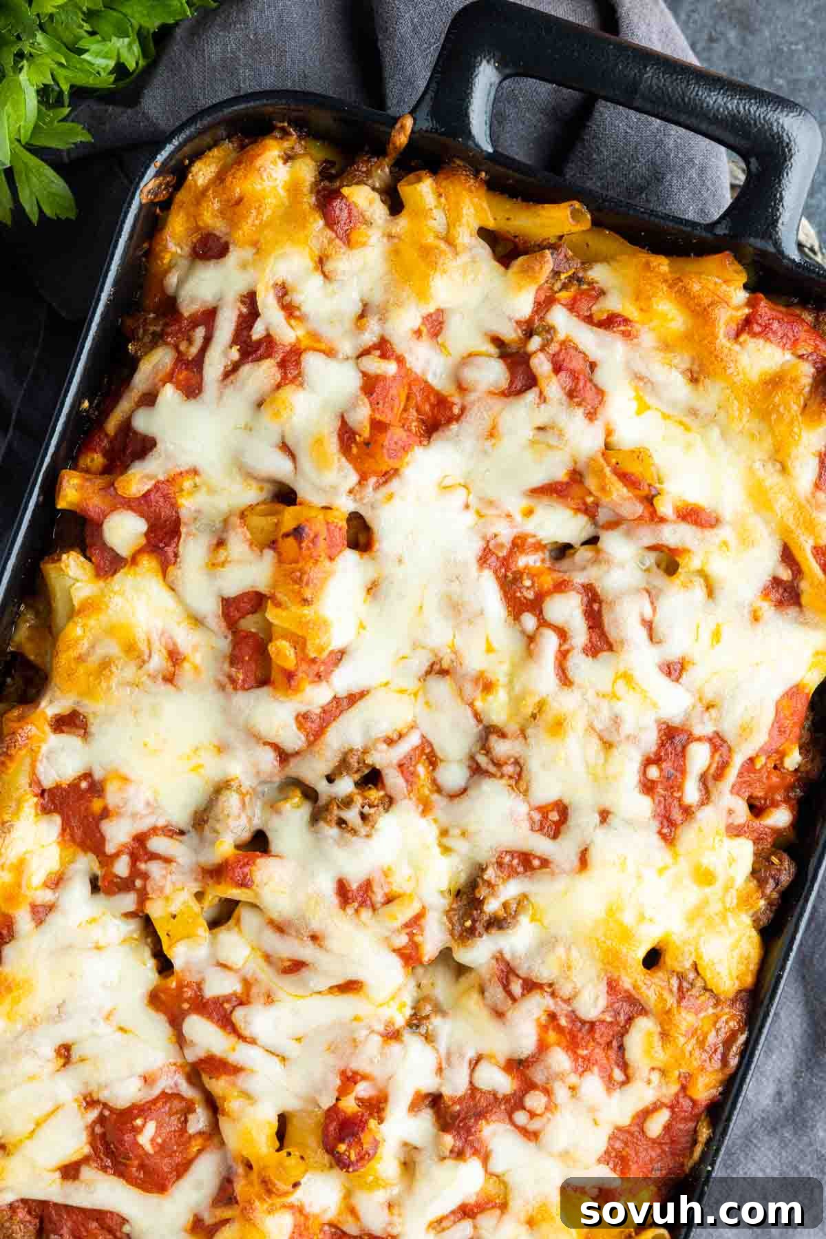 Sausage Baked Ziti, freshly baked and bubbling, presented in a black baking dish, ready to be served.