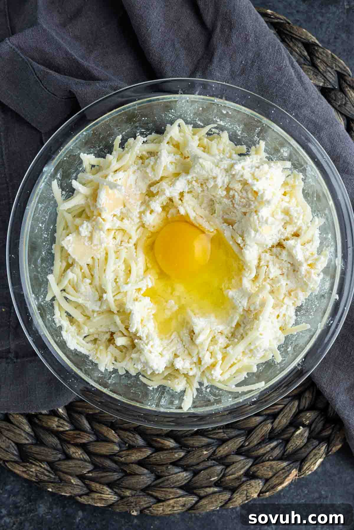 A bowl of creamy ricotta and cheese mixture, perfectly blended and ready for layering in the Sausage Baked Ziti.