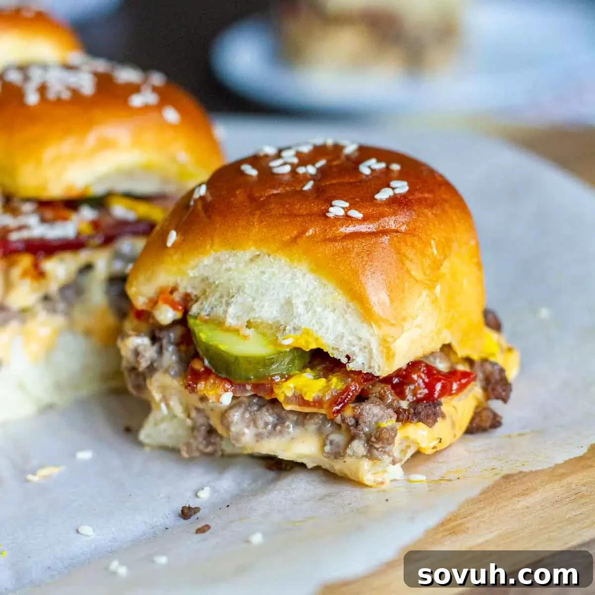 Delicious Bacon Cheeseburger Sliders garnished with pickles, ready to serve