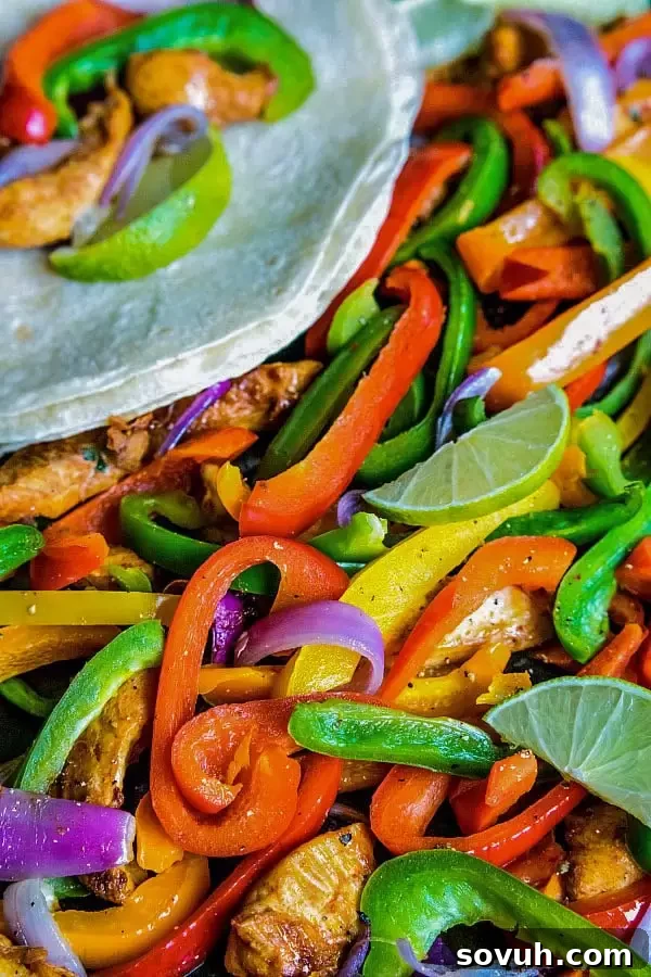Close-up of chicken fajitas on a sheet pan, ready to serve