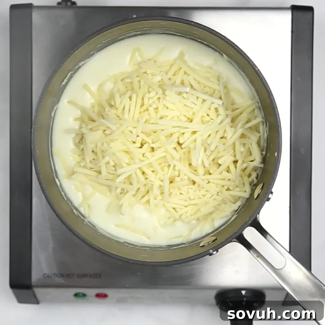 Melted cheese in a pan on a white surface to make asparagus casserole