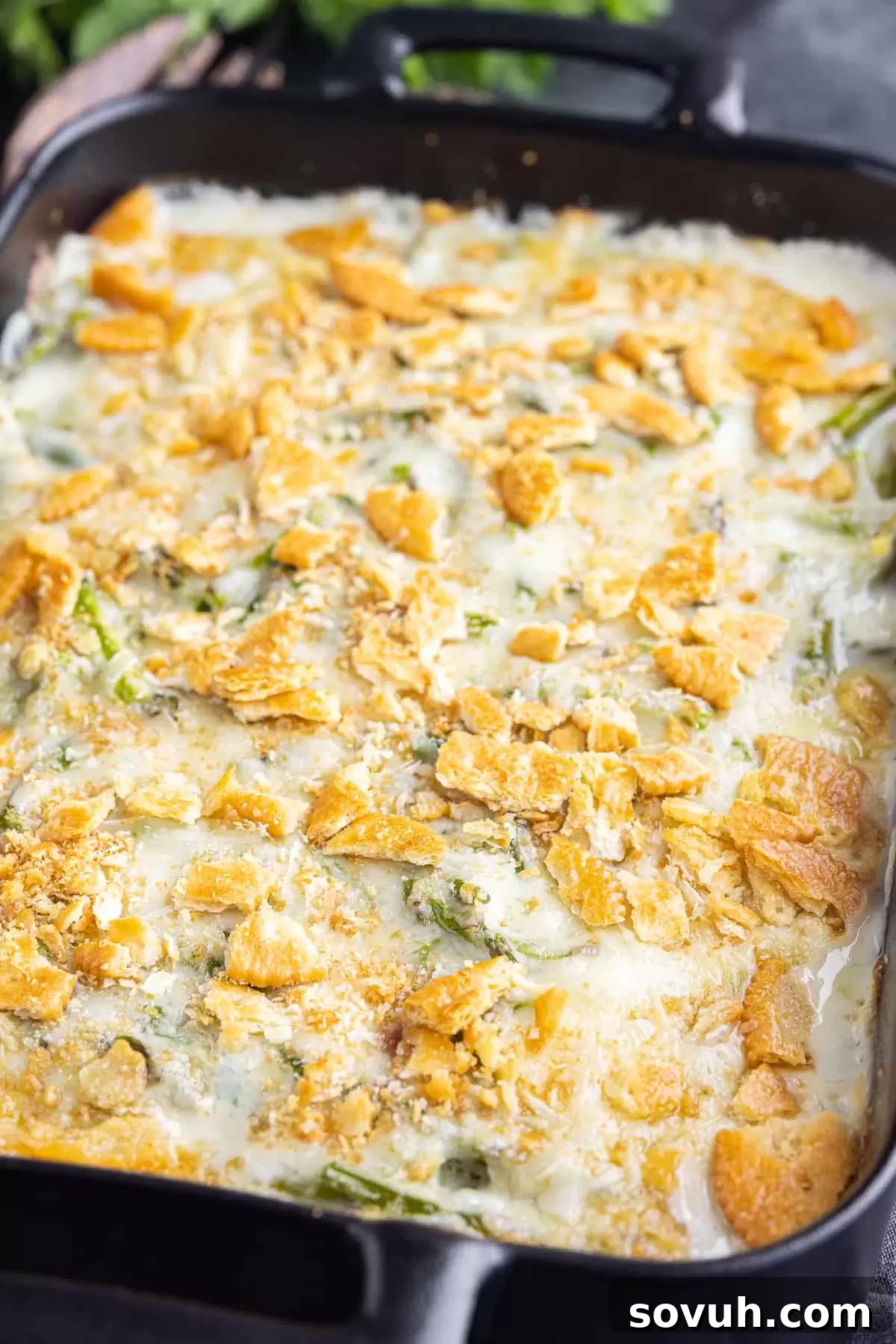 Asparagus Casserole made with hard boiled eggs and bacon on a rustic wooden background