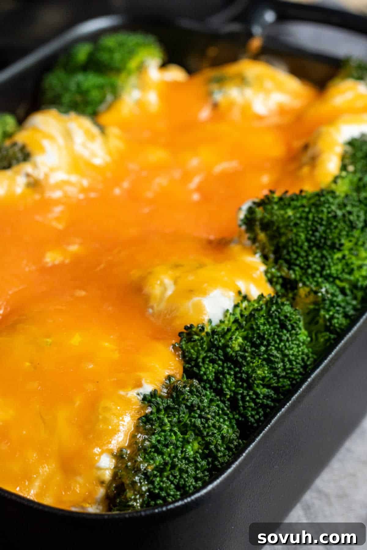 Broccoli Cheese Casserole in a black baking dish, baked to golden perfection