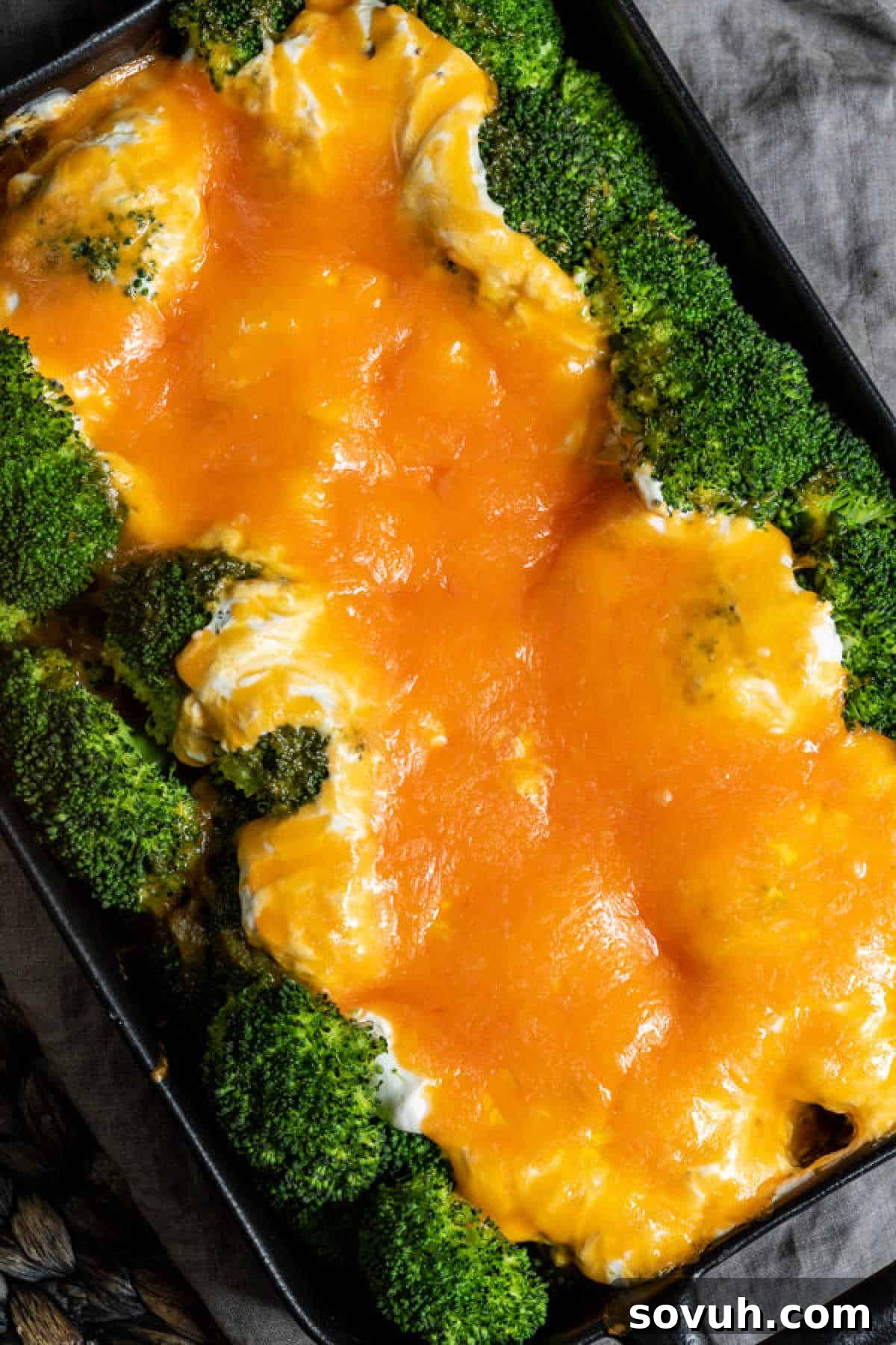 Broccoli Cheese Casserole topped with golden shredded cheddar cheese, fresh from the oven