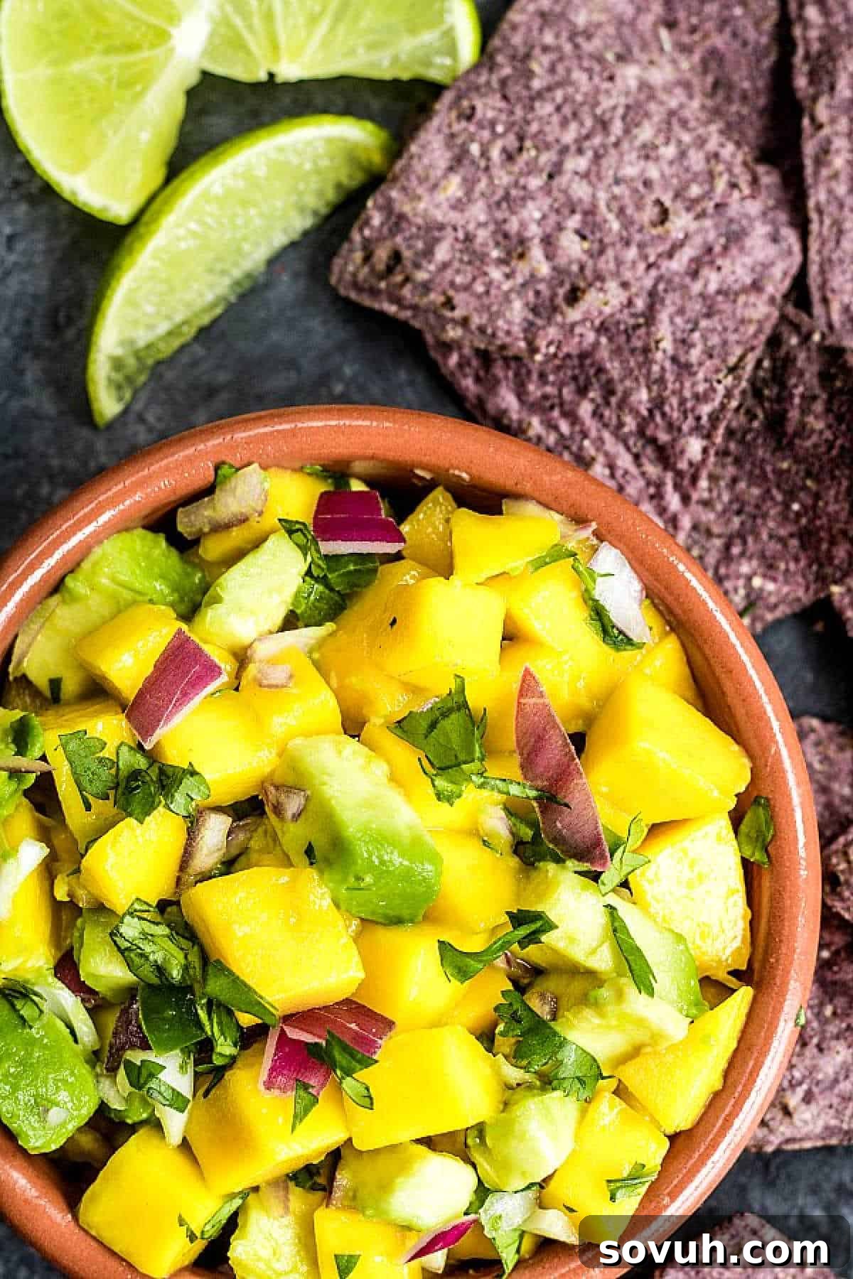 bowl with Mango Salsa with blue tortilla chips
