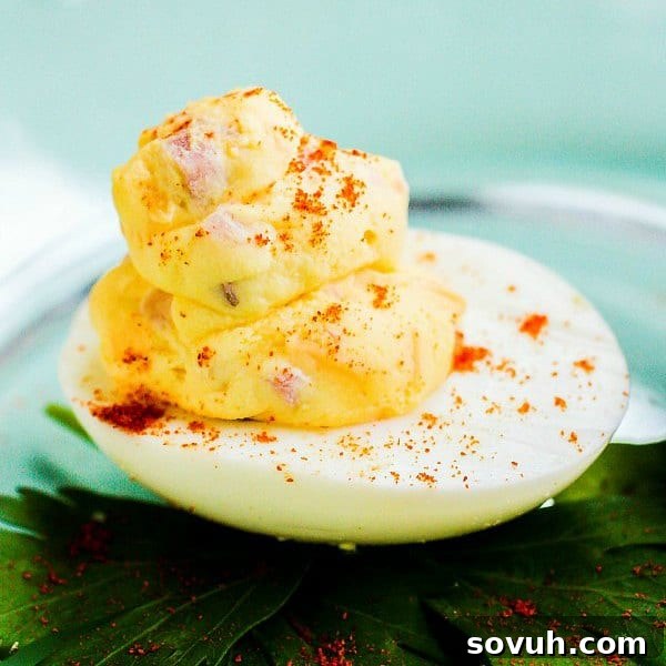 Mississippi Sin deviled egg filled with ham and cheese garnished with paprika, ready to be served