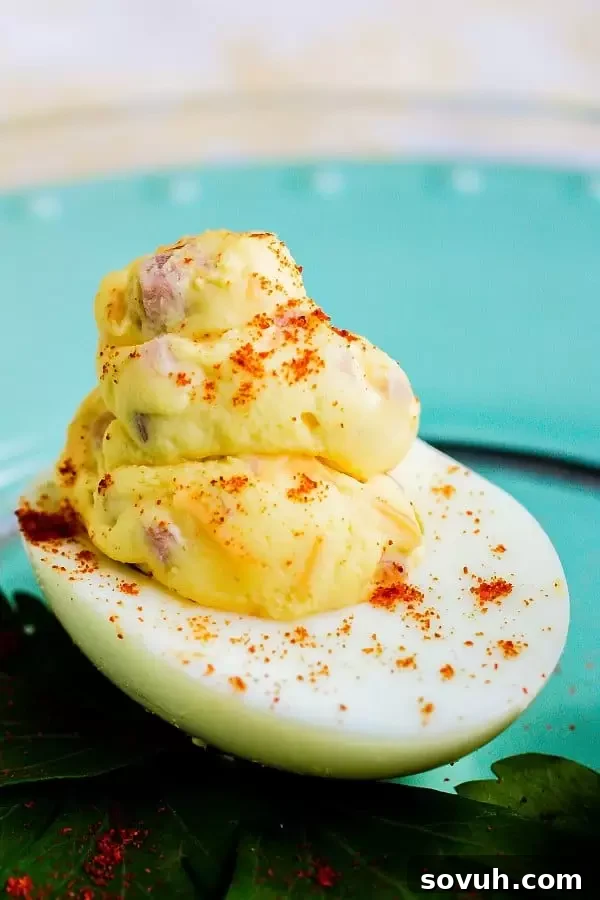 A platter of beautifully arranged Easter Mississippi Sin deviled eggs, filled with ham and cheese