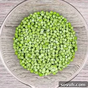 Velvety Spring Pea Salad 12 a glass bowl of frozen peas to make english pea salad