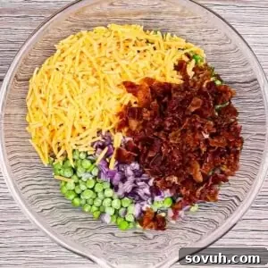 Velvety Spring Pea Salad 13 mixing ingredients in a glass bowl for english pea salad